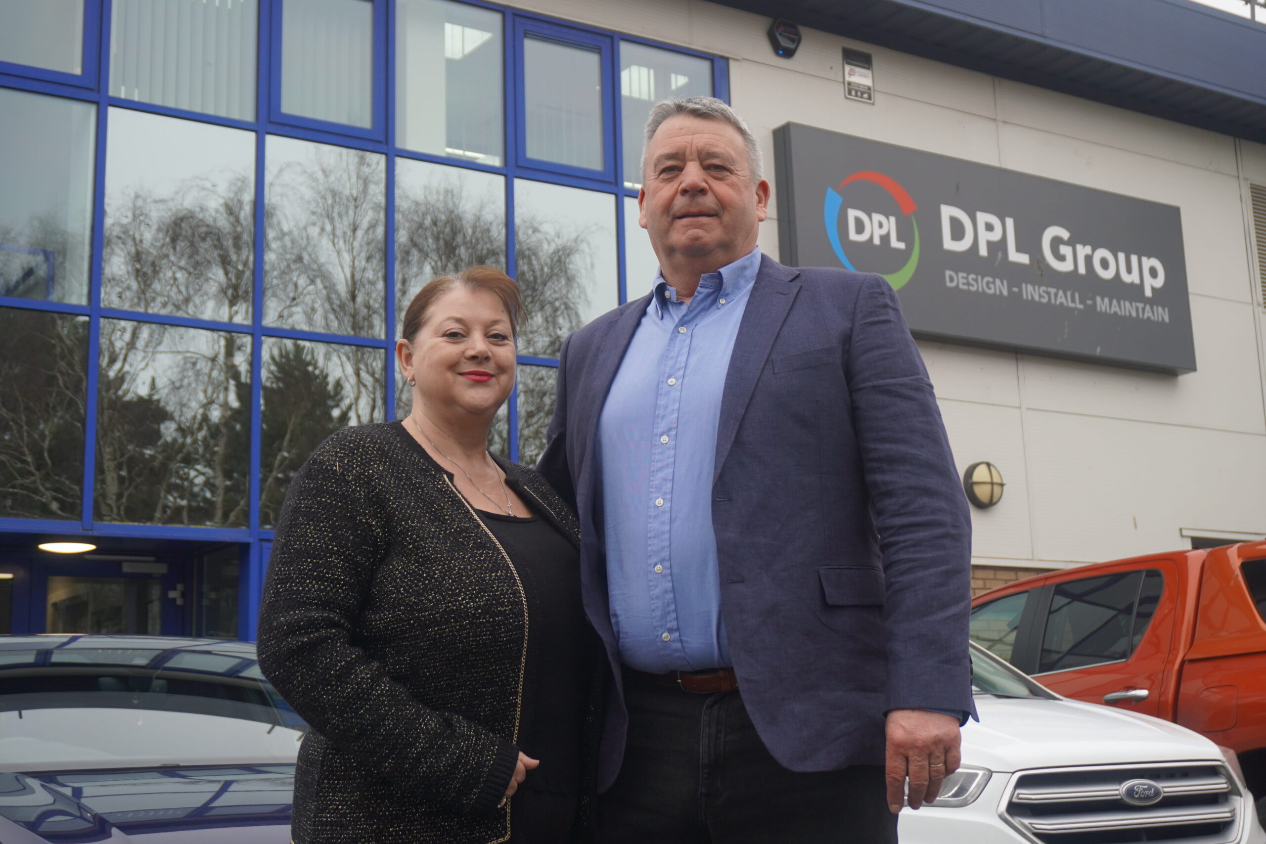 Gary and Fran Dinsdale, founders of DPL Group, standing outside the company’s headquarters ahead of their retirement.